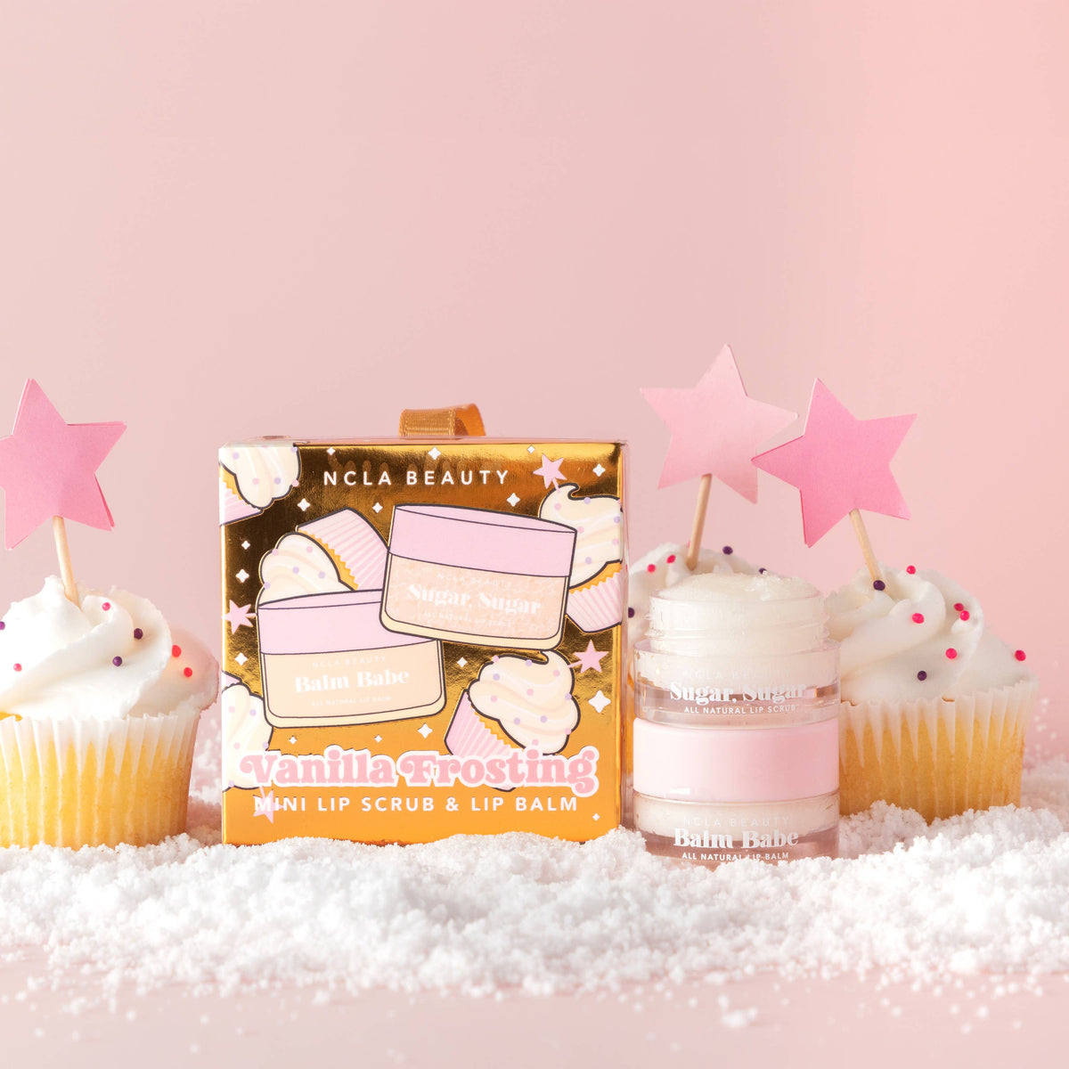 Christmas gifts of natural beauty featuring NCLA lip scrub and balm with cupcakes and festive decor.