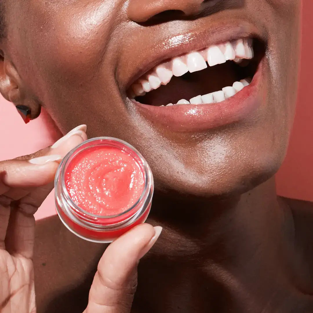 Smiling person holding Sugar, Sugar Watermelon Lip Scrub from Watermelon Lip Care Set + Lip Scrubber.
