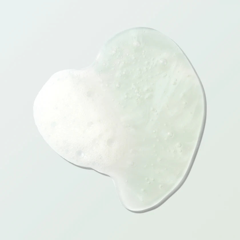 Close-up of foamy Coconut Shower Gel displaying its rich texture and nourishing properties.