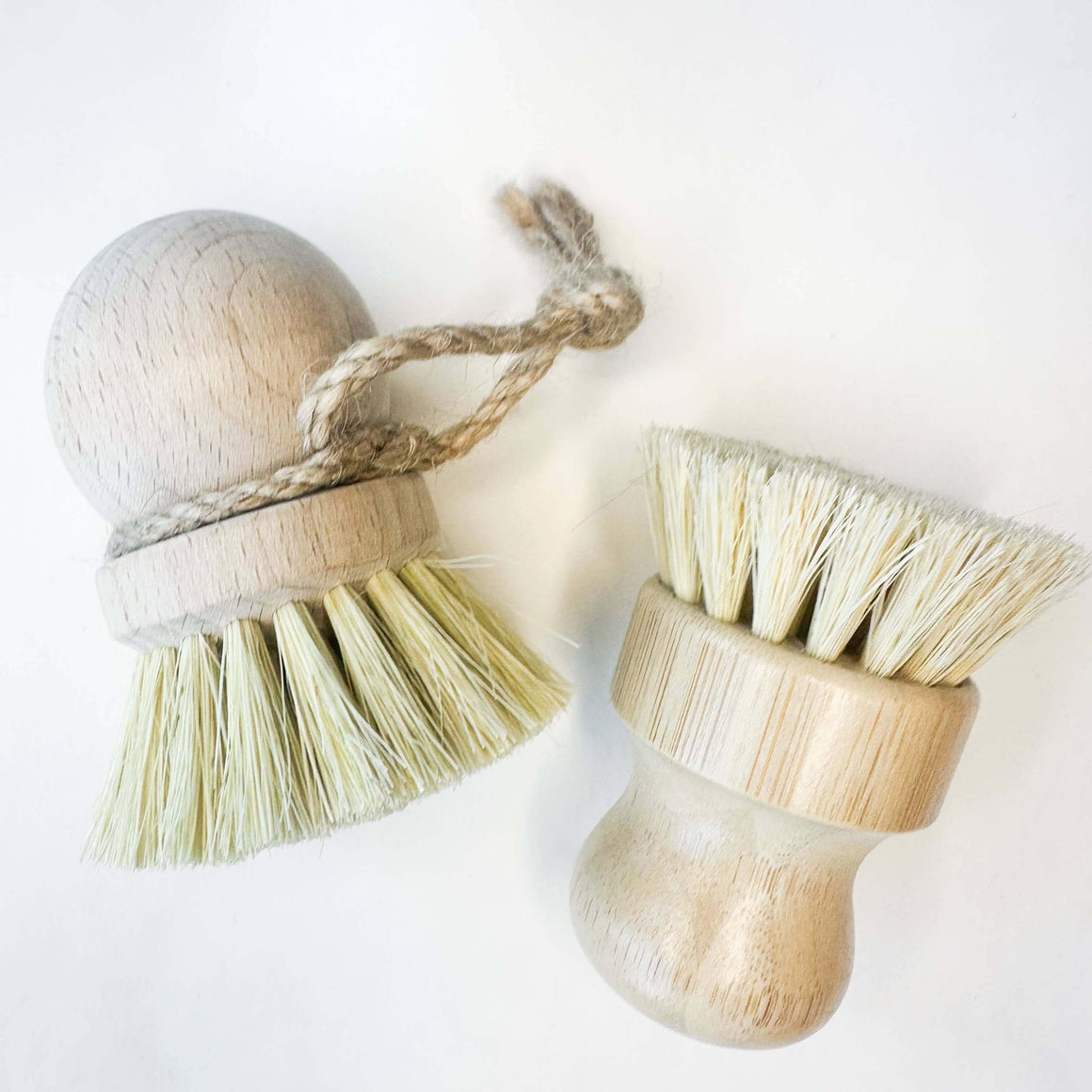 Two wooden brushes with bristle heads on a white background