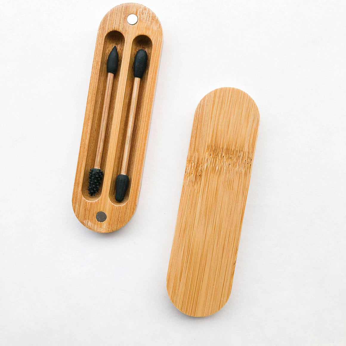 Bamboo toothbrush case with black bristle toothbrushes on a white background