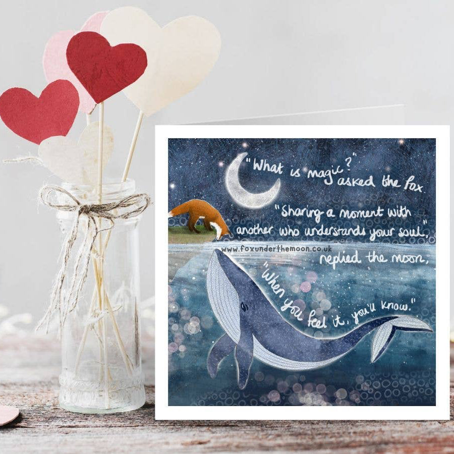 Card with whale illustration and inspirational quote next to heart-shaped objects in a jar.