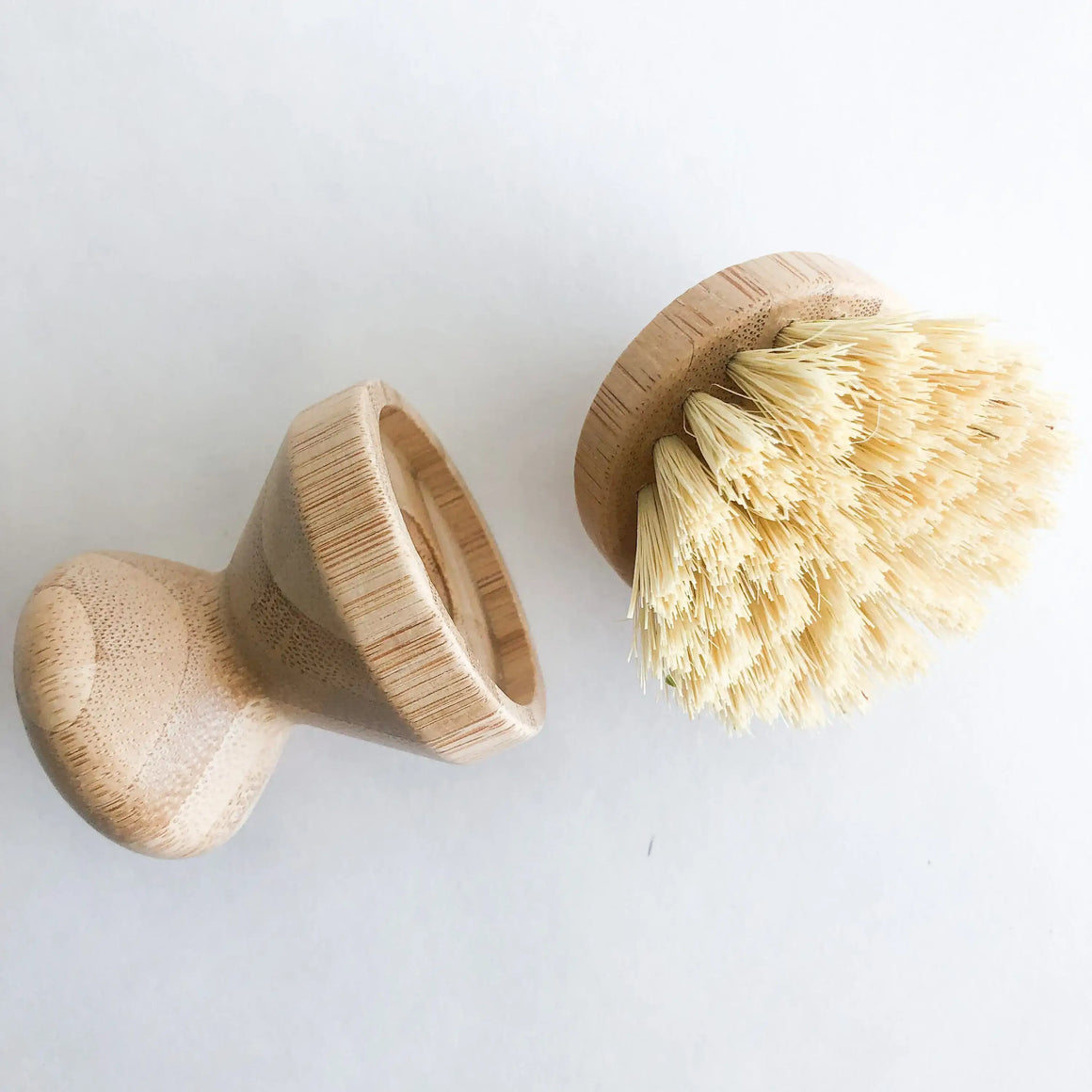 Two wooden brushes with natural bristles on a white background
