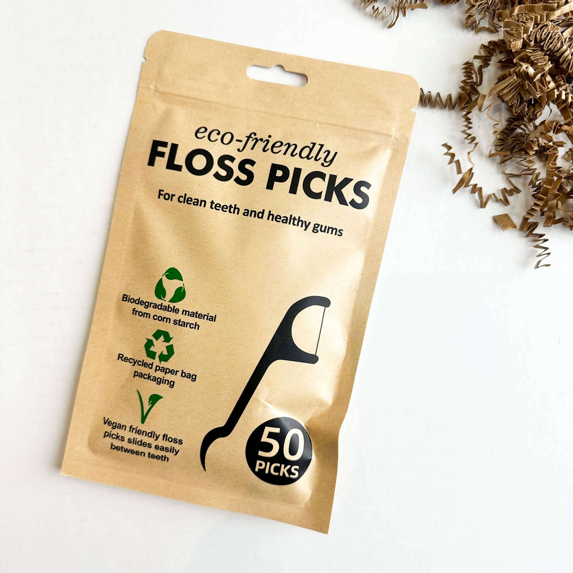 Eco-friendly floss picks packaging showing biodegradable material and recycled paper, perfect for healthy teeth.