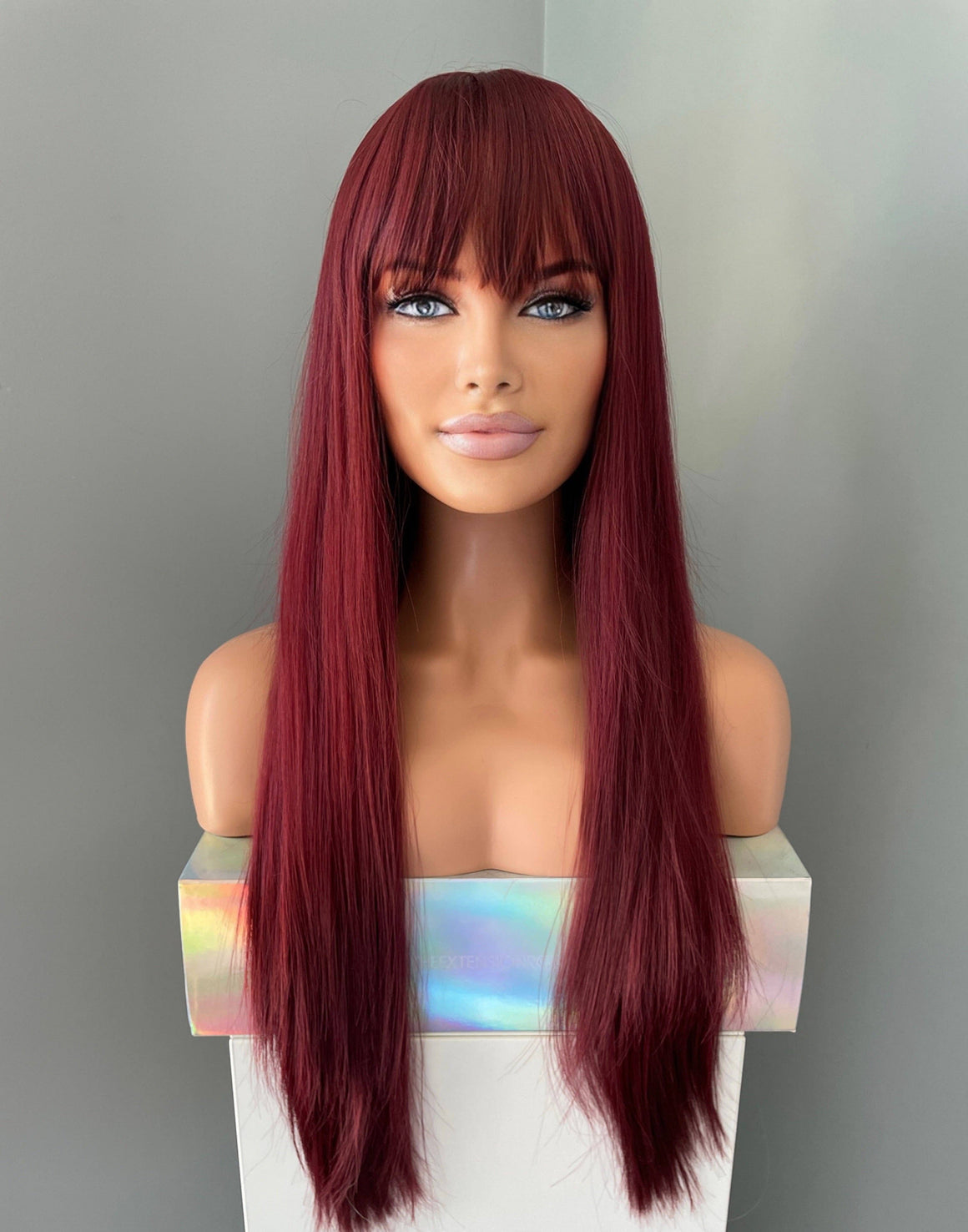 Long wine red silky straight wig with bangs displayed on a mannequin bust against a neutral background.