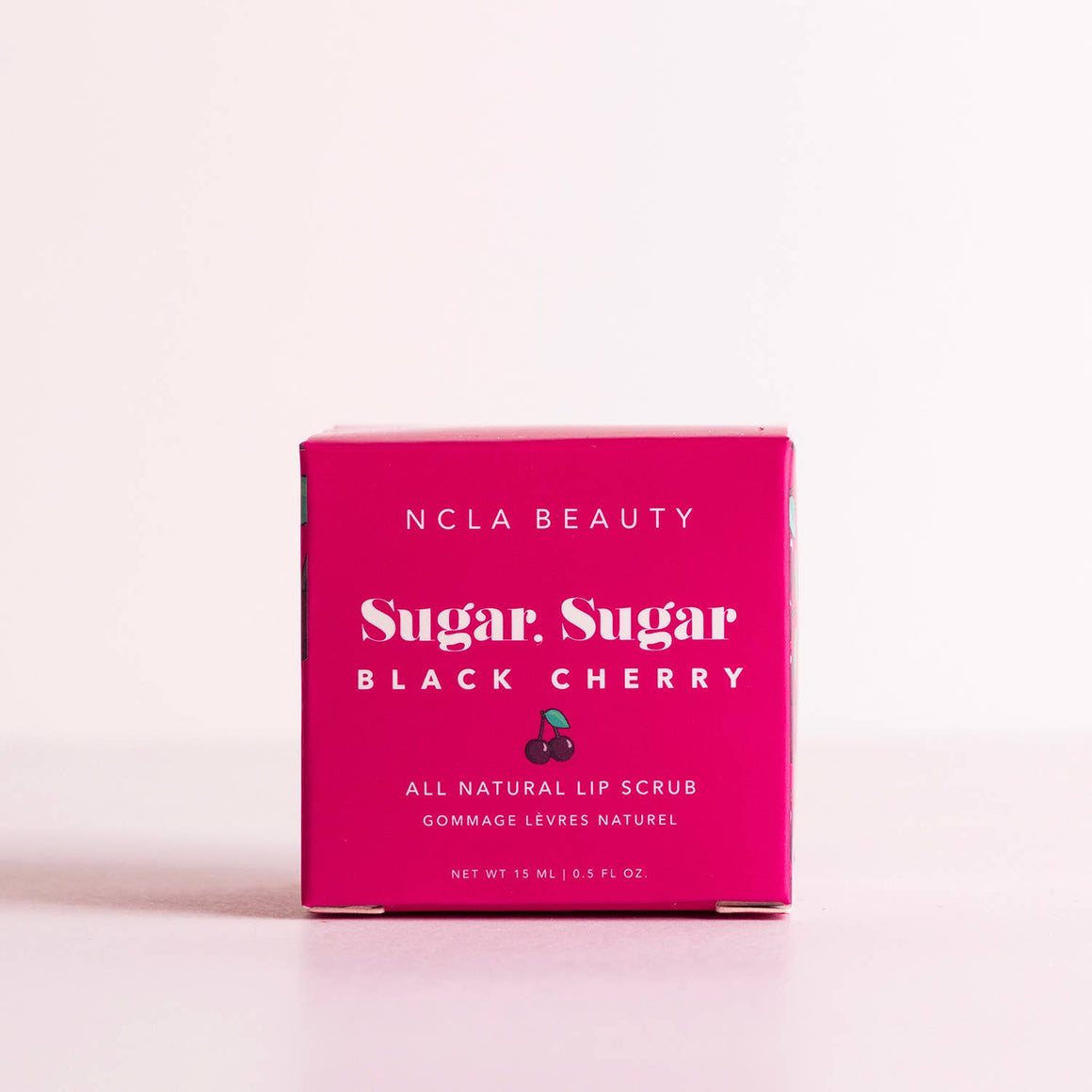 NCLA Beauty Sugar, Sugar Black Cherry lip scrub packaging on a light pink background