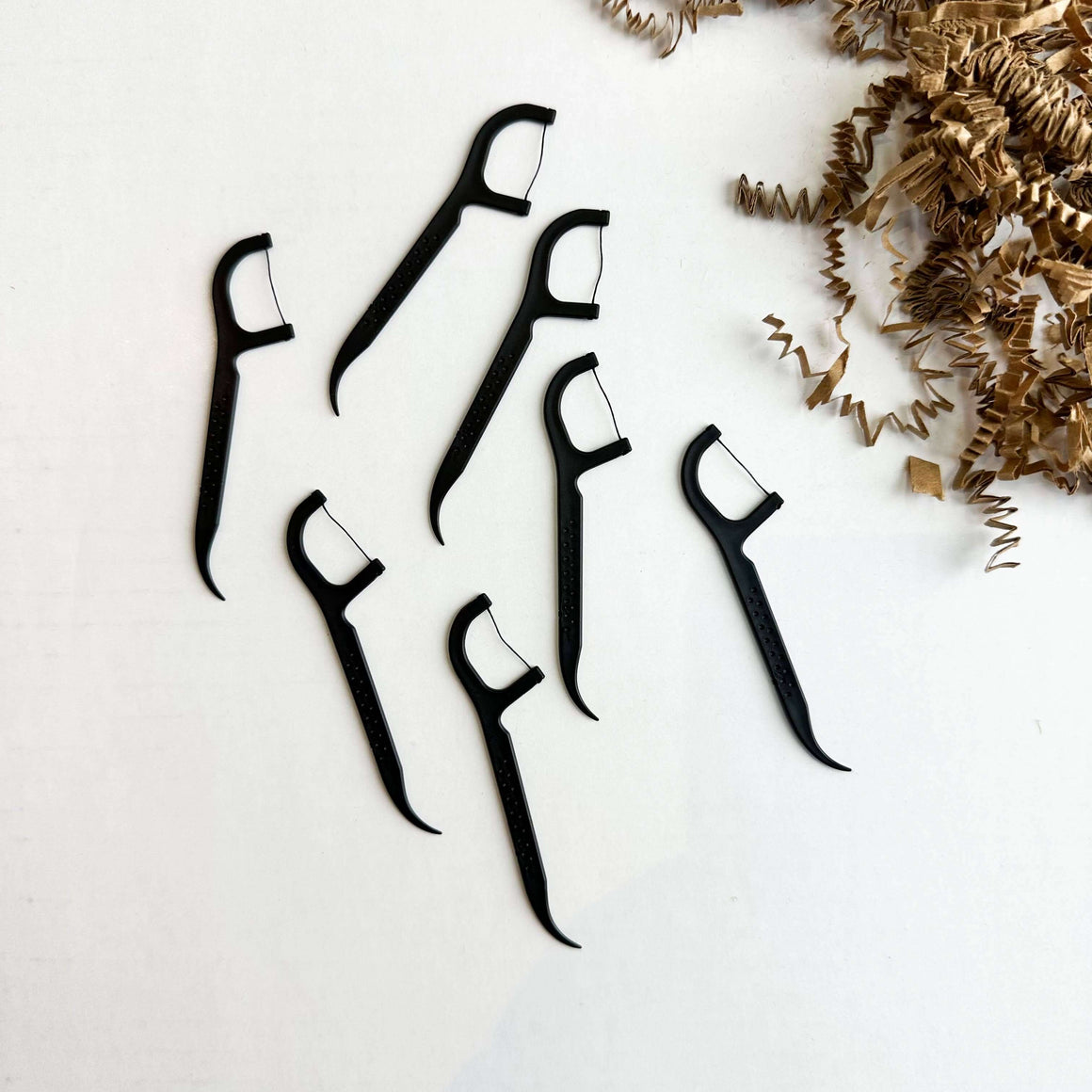 Biodegradable Floss Picks by Smile Boutiques displayed against a white background.