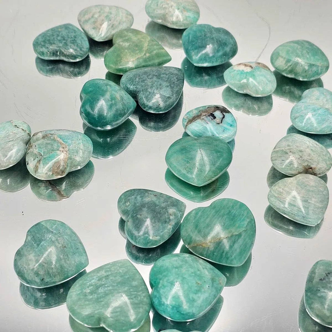 Turquoise stones on a reflective surface