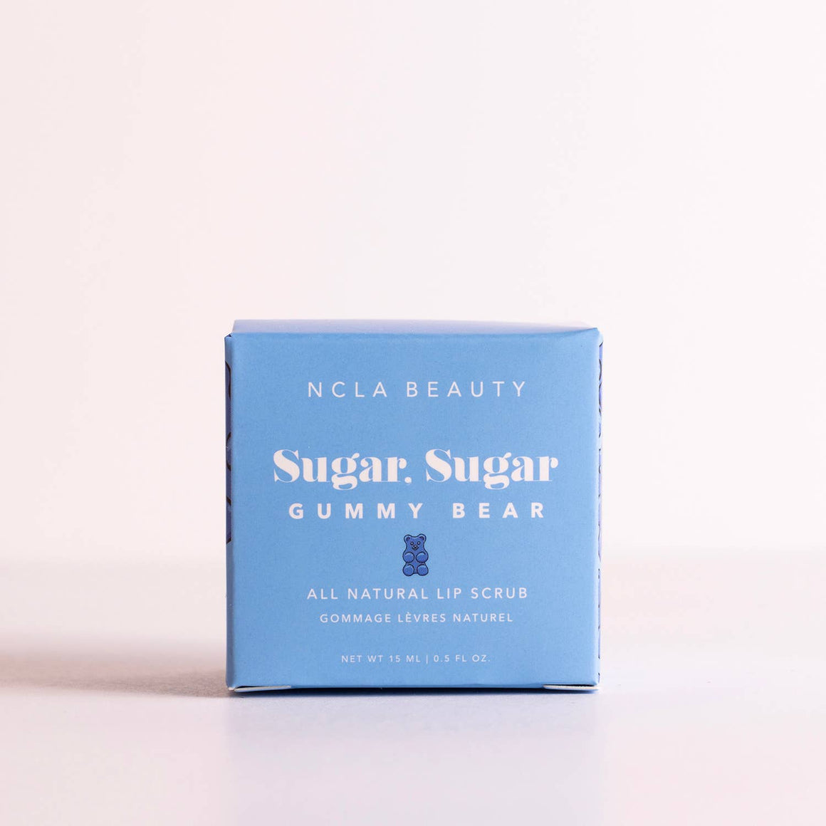 NCLA Beauty Sugar Sugar Gummy Bear lip scrub packaging on a light background