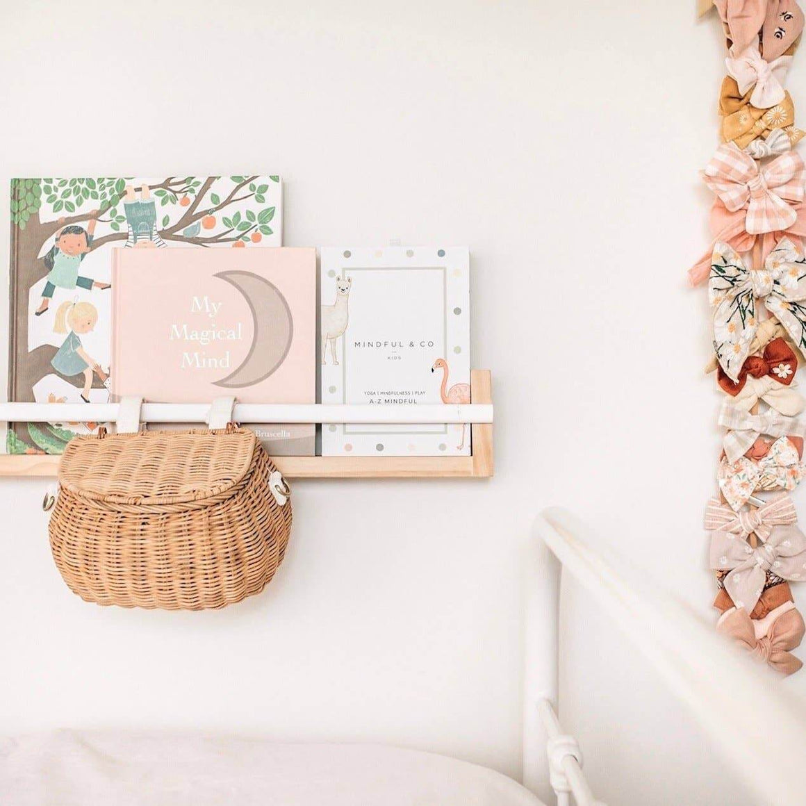 Children's room with books, a basket, and decorative items on a shelf.