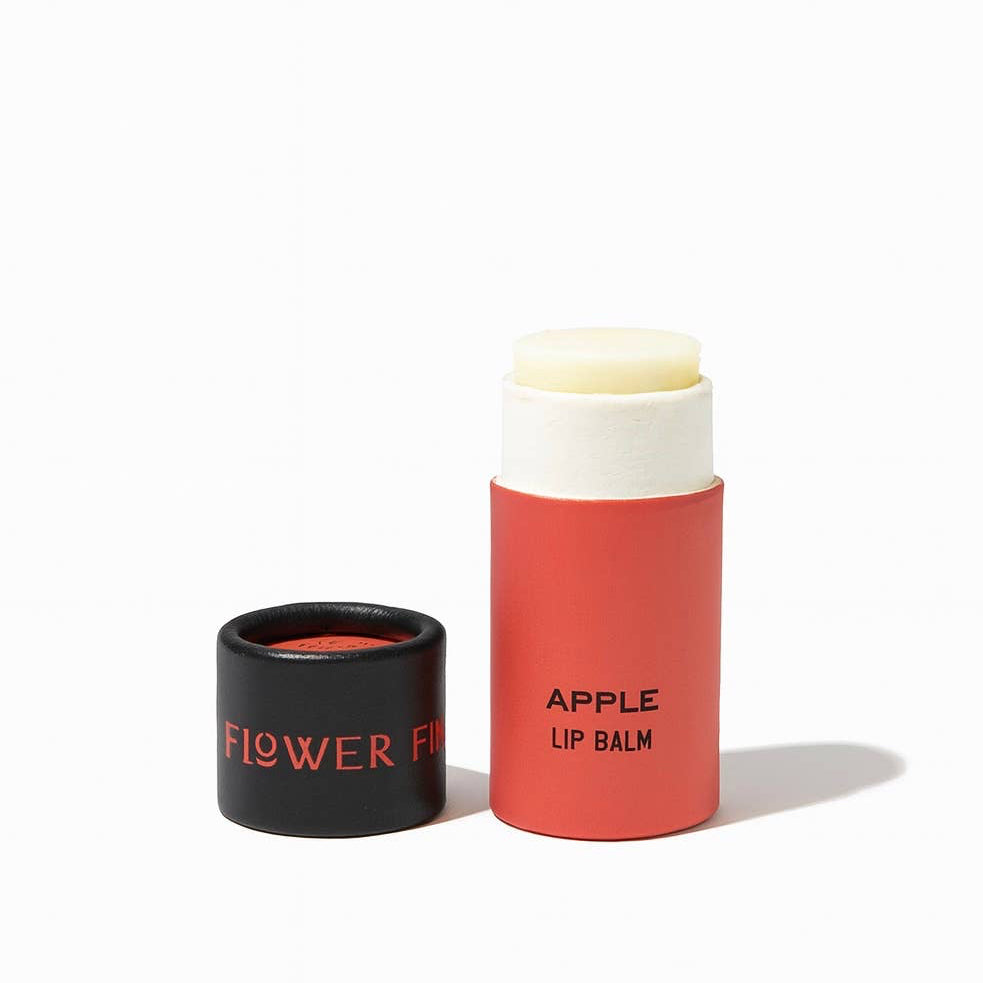 Apple Organic Lip Balm in red tube with black lid, eco-friendly and nourishing for soft lips.