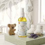 Baby Oil - Nourishing Avocado & Lavender 100ml - Earthie Koala on a shelf with lavender and baby items.