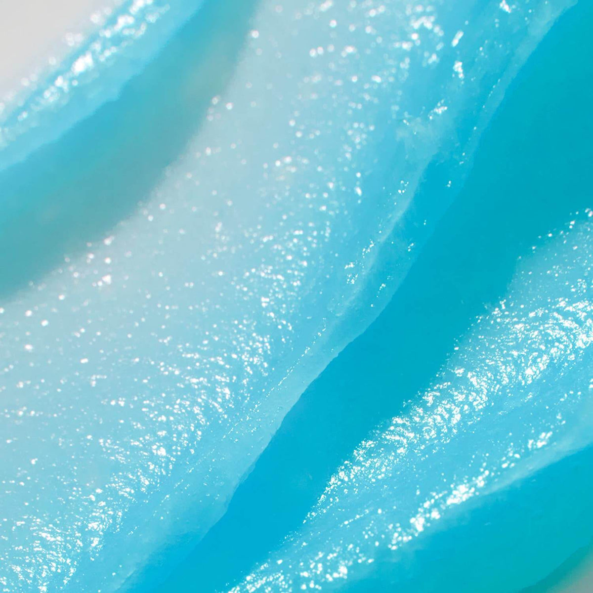 Close-up of blue glittery slime with a gradient effect.
