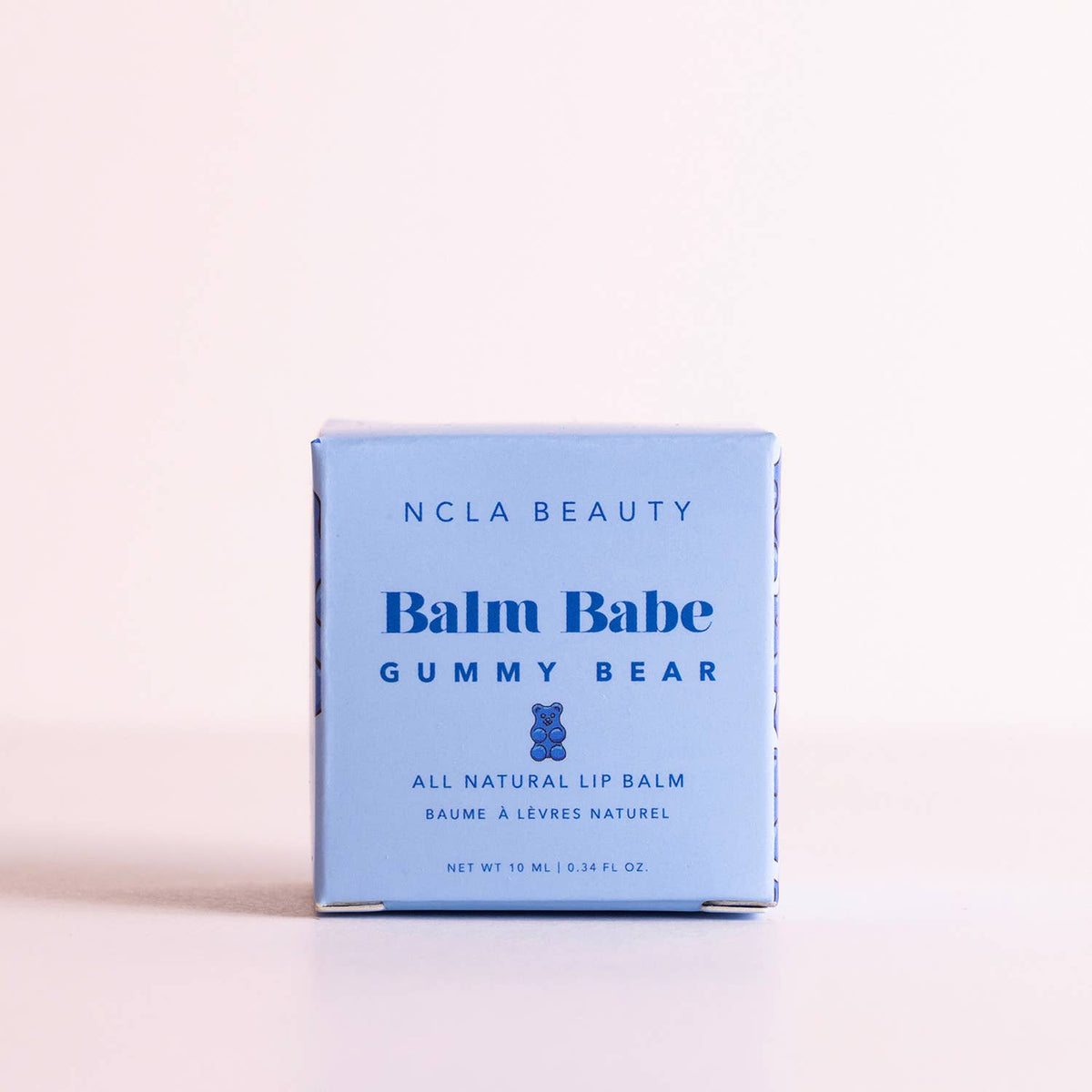 NCLA Beauty Balm Babe Gummy Bear lip balm packaging on a light pink background