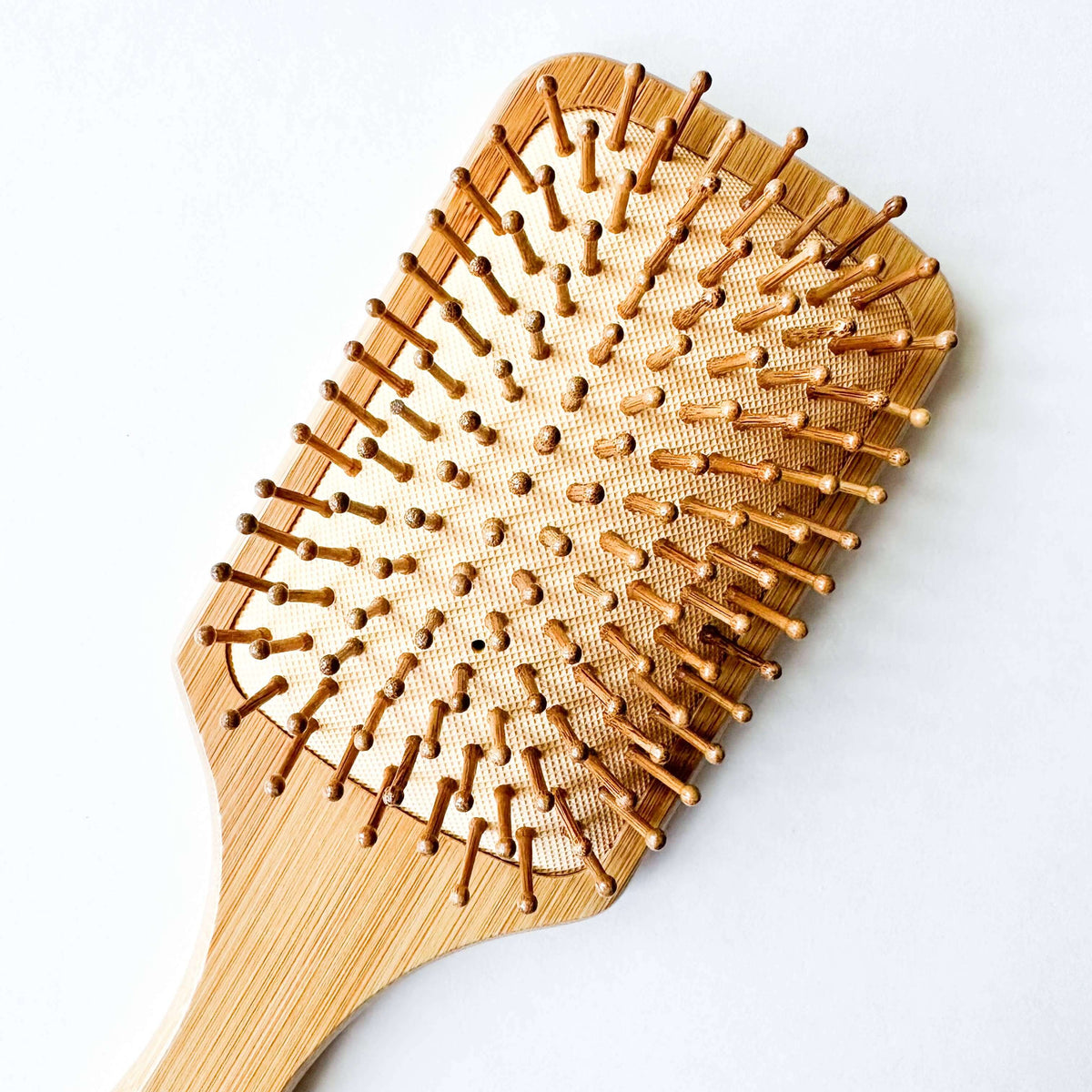 Wooden hairbrush on a white background