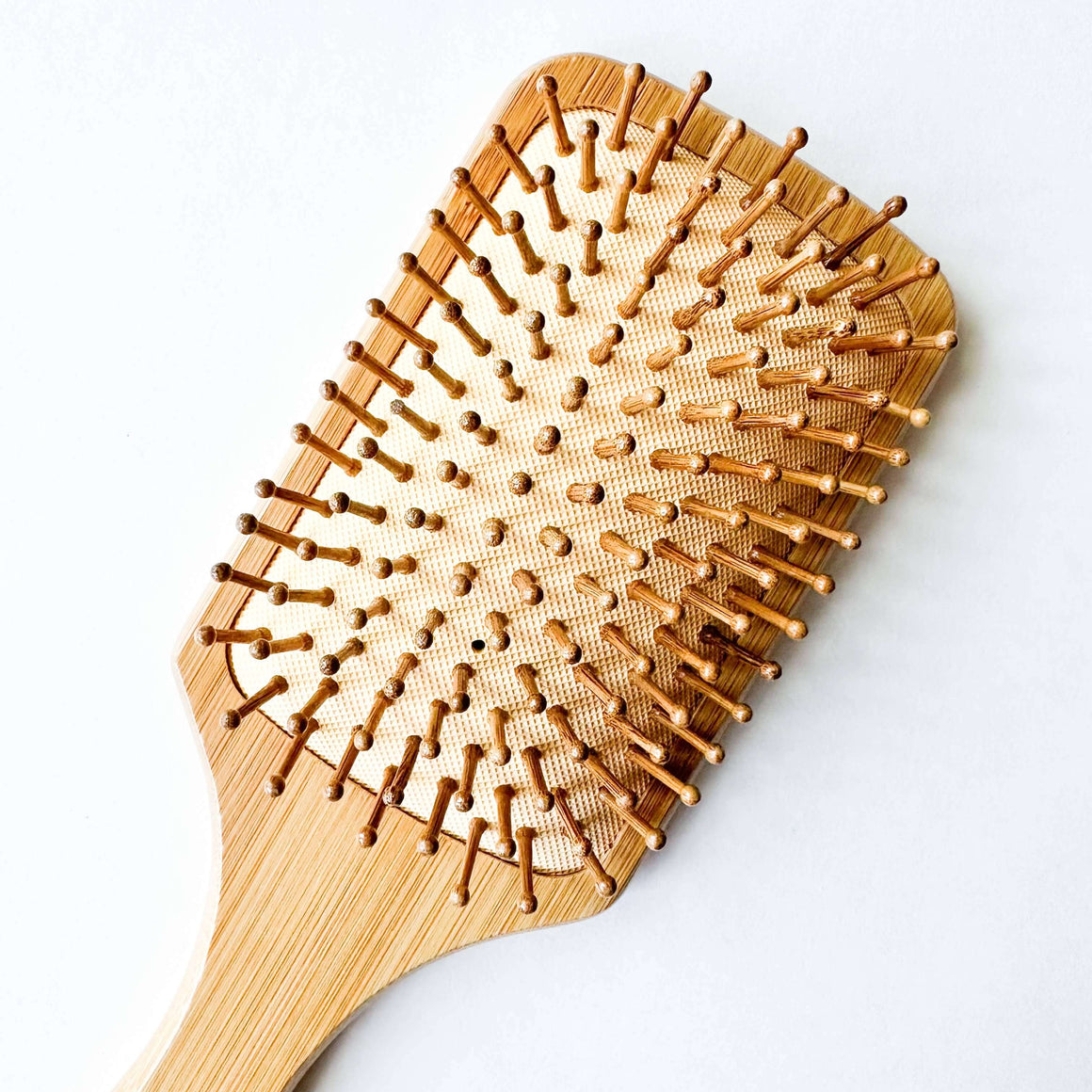 Wooden hairbrush on a white background