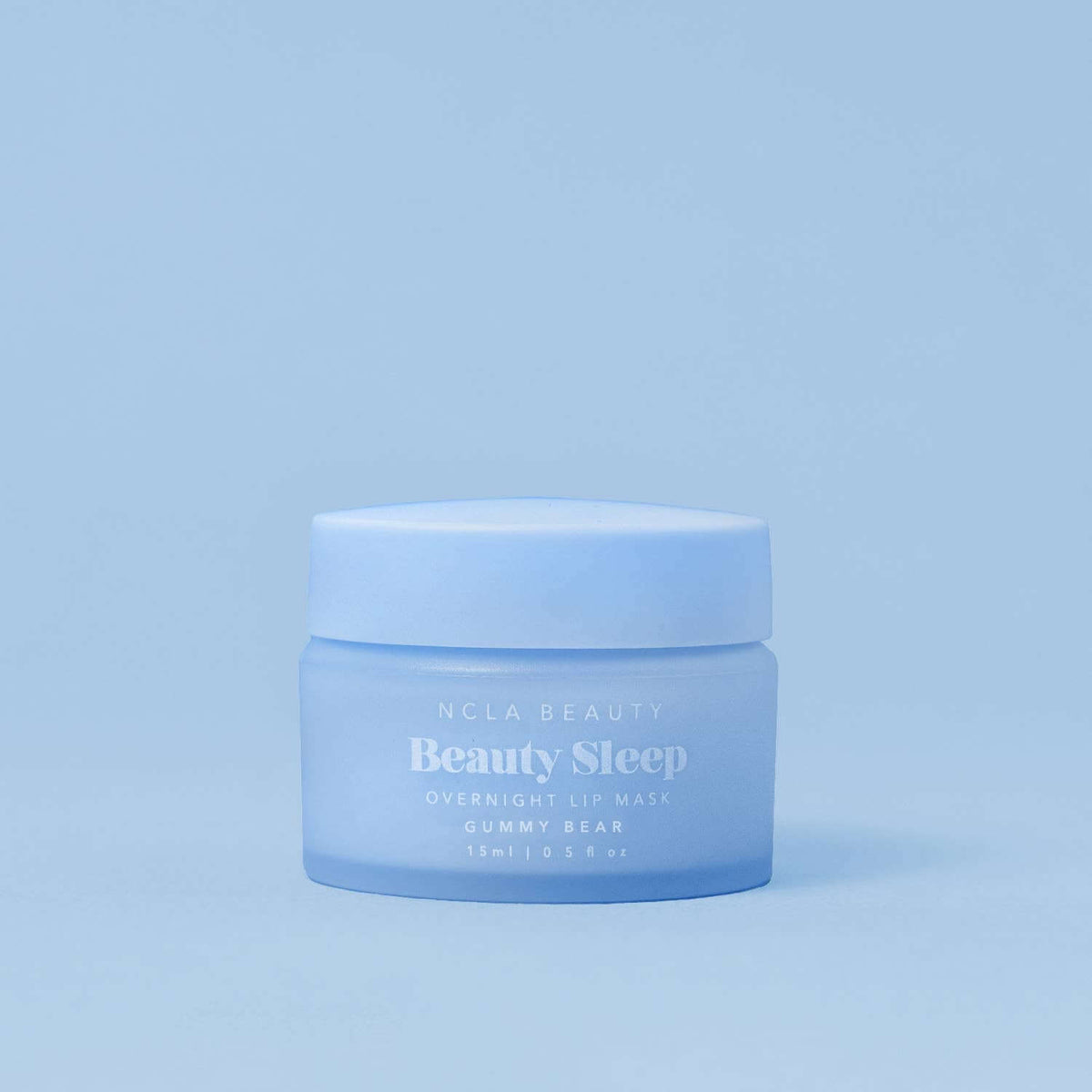 Blue jar of NCLA Beauty Beauty Sleep lip mask on a light blue background