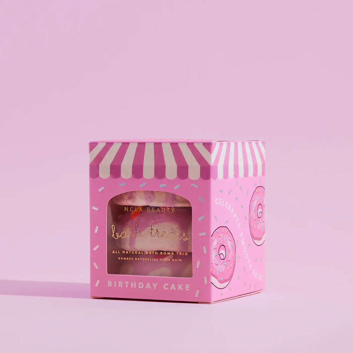 Pink bath bomb box with striped lid on a pink background