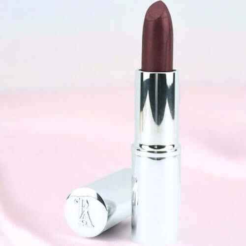 Lipstick with silver cap on a gradient pink background