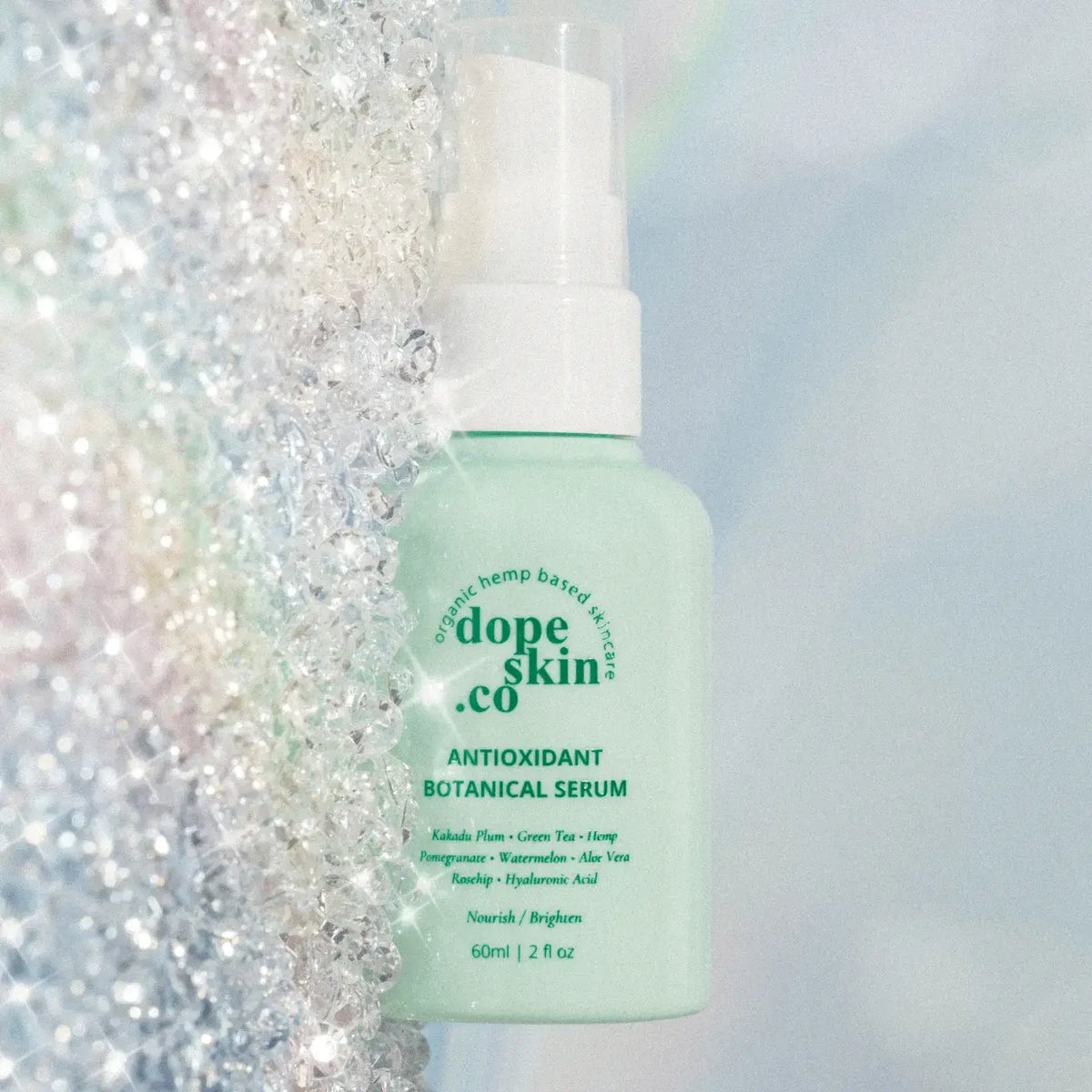 Bottle of Dope Skin Co. Antioxidant Botanical Serum on a glittery background