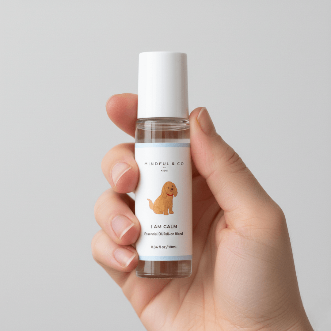 Hand holding a bottle of 'I AM CALM' essential oil by Mindful & Co on a light gray background
