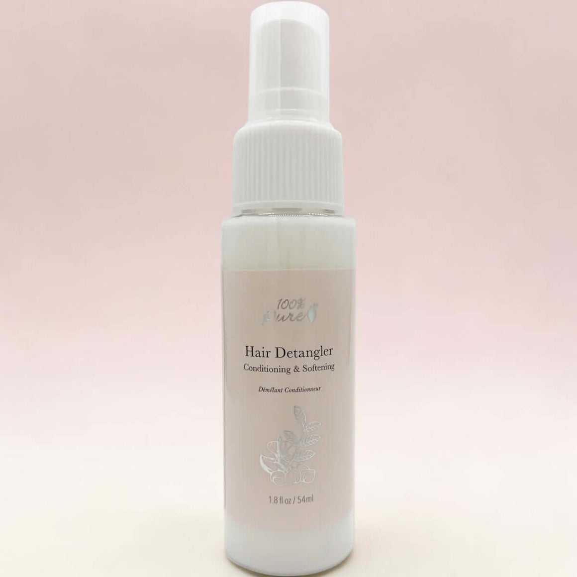Hair detangler spray bottle on a light pink background