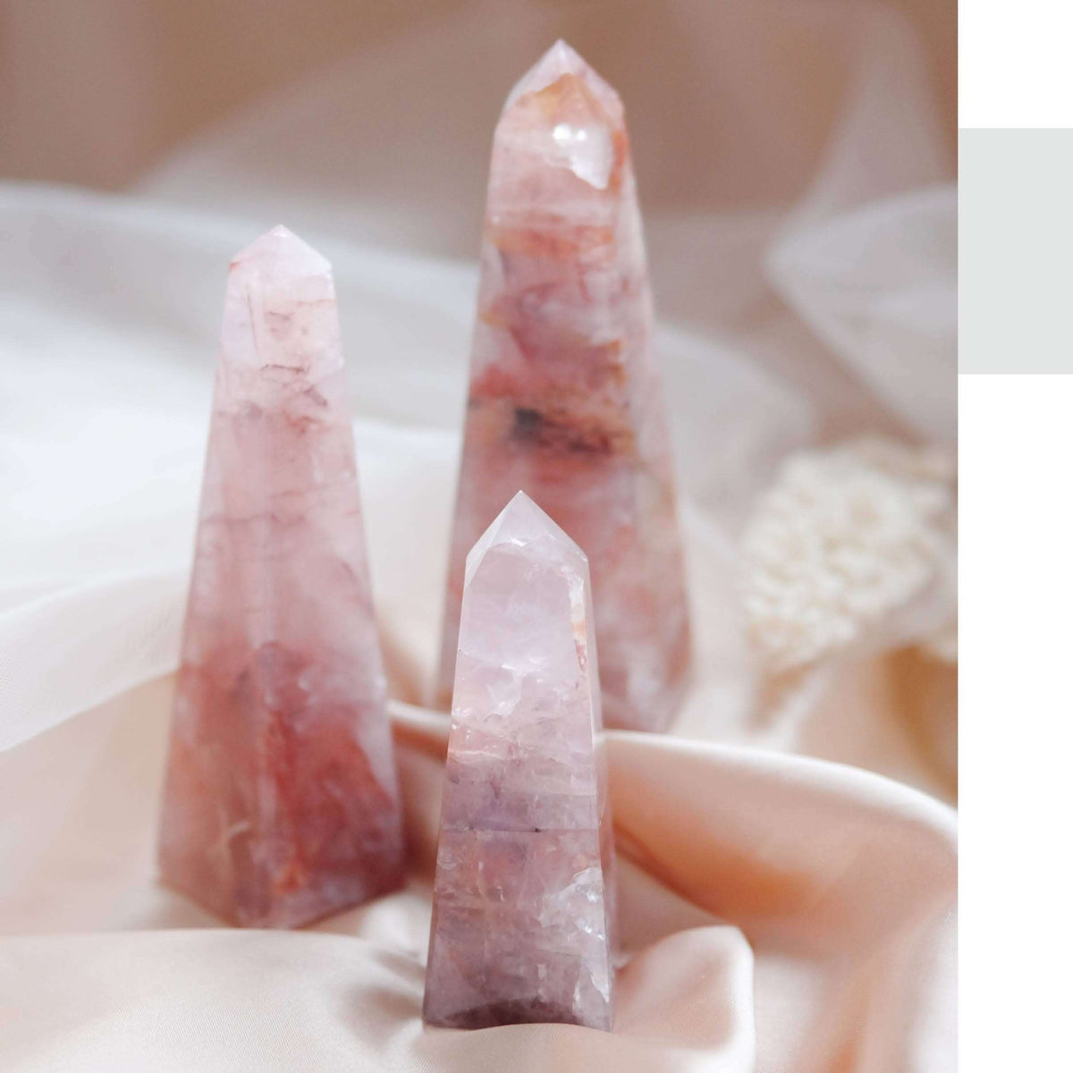 Close-up of pink crystal points held in hands with a text page on integrating knowledge, observance, and rest.