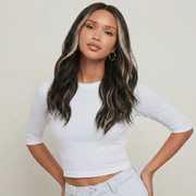 Dani Black Bodywave Wig with Blonde Highlights styled on a model, showcasing soft waves and a modern middle part.