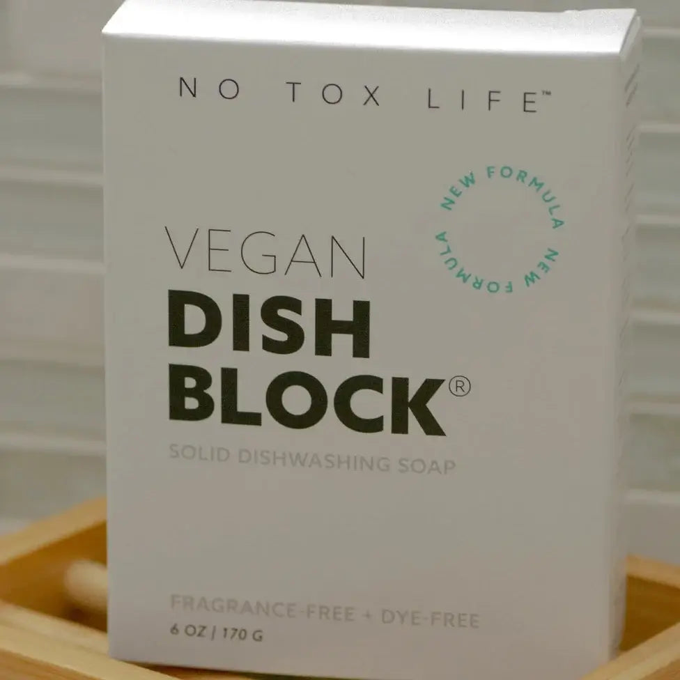 Box of No Tox Life Vegan Dish Block on a wooden surface
