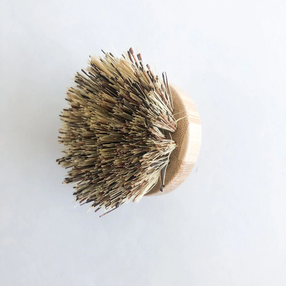Bristle brush with wooden handle on a white background