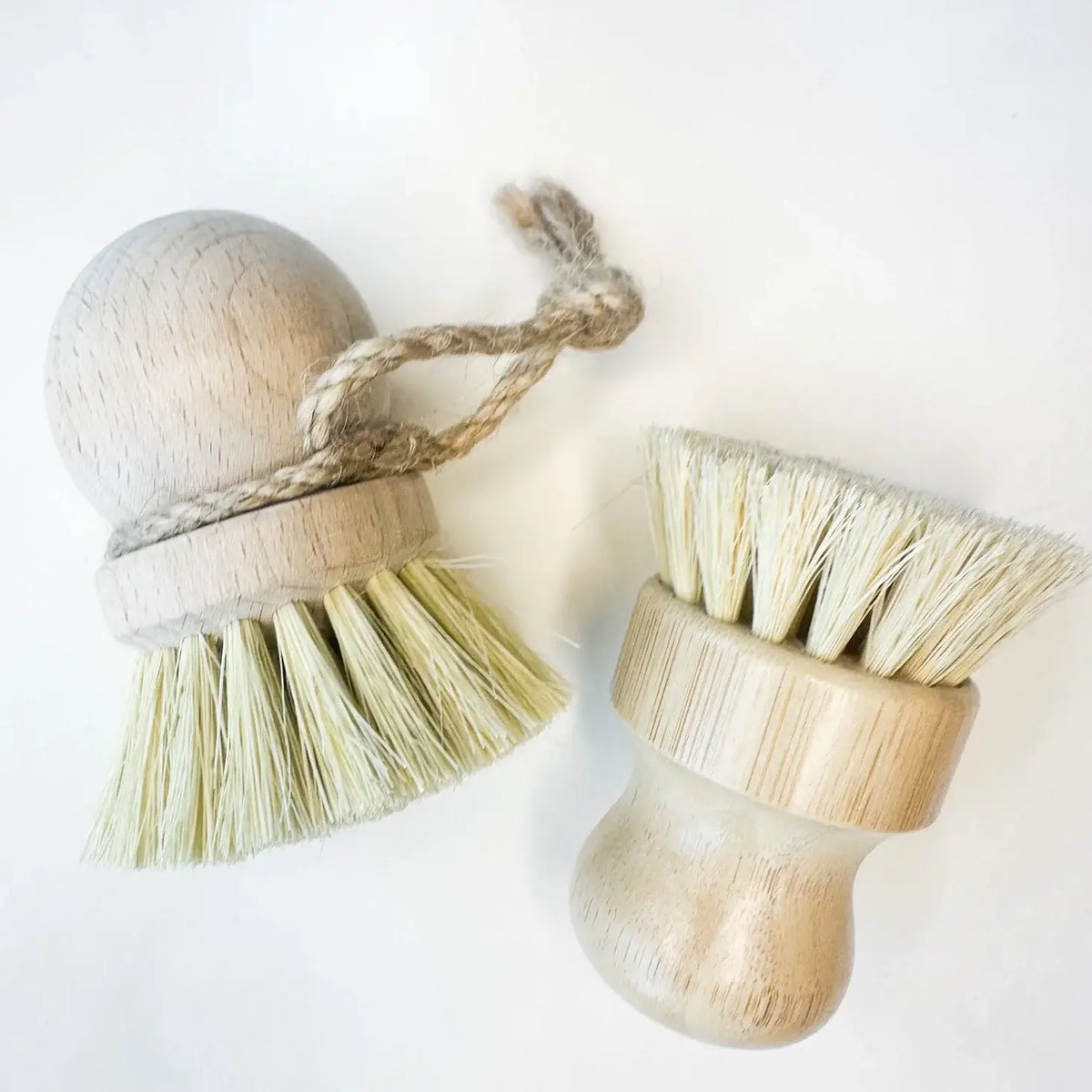 Two wooden brushes with bristle heads on a white background