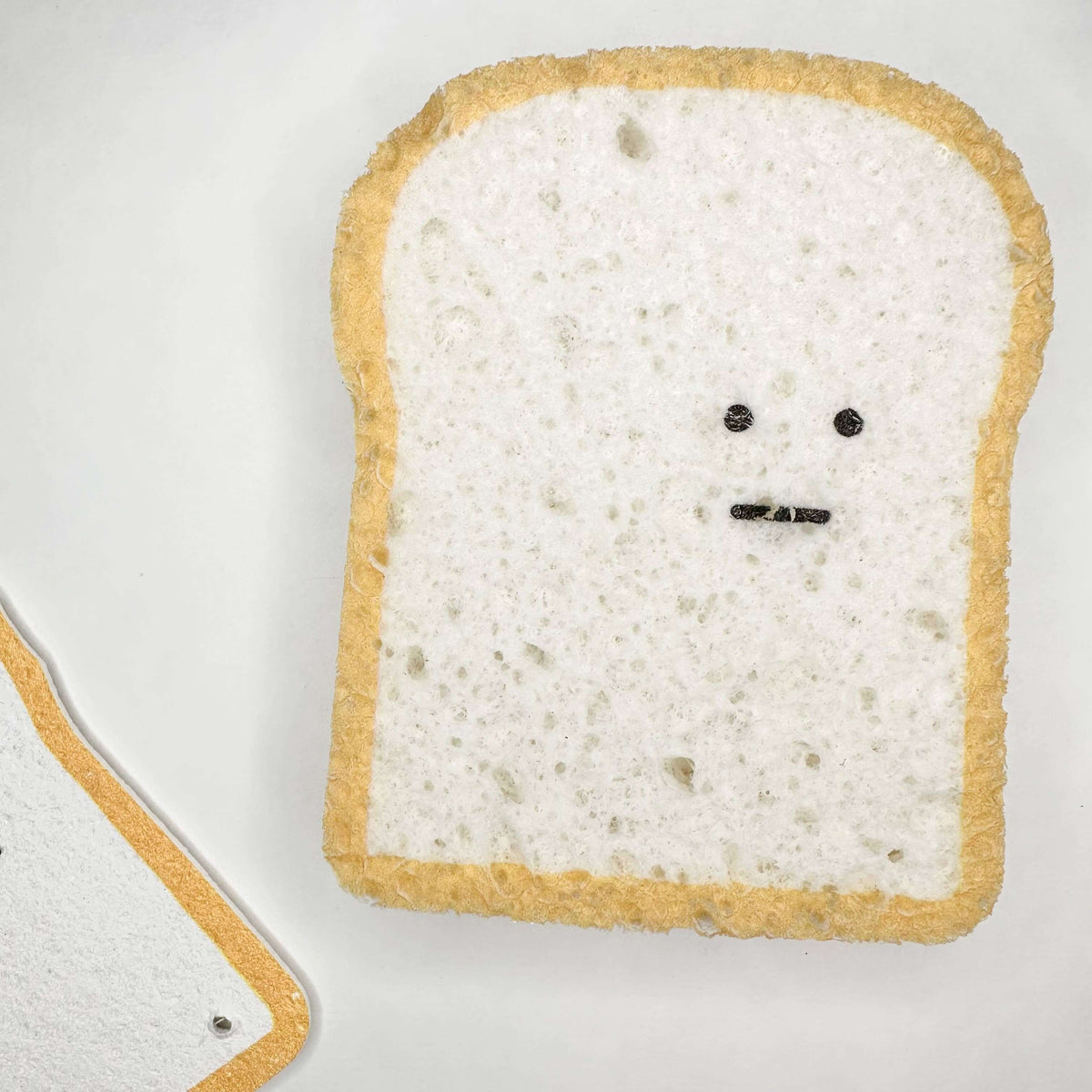 Toast with a face drawn on it on a white background