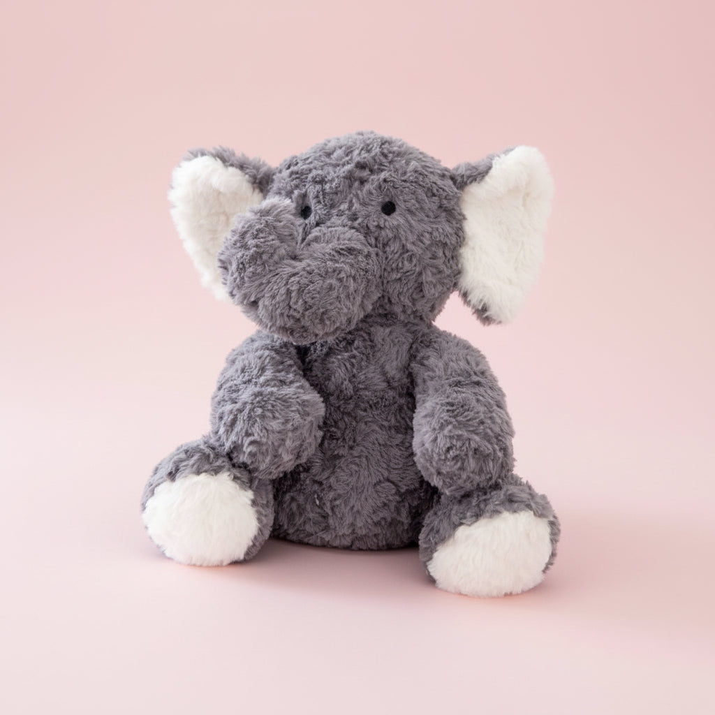 Plush elephant toy with gray body and white feet and ears on a white background