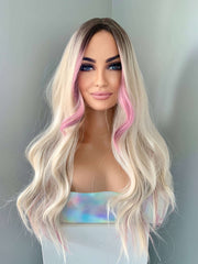 Mannequin head with long blonde wig with pink ends on a plain background