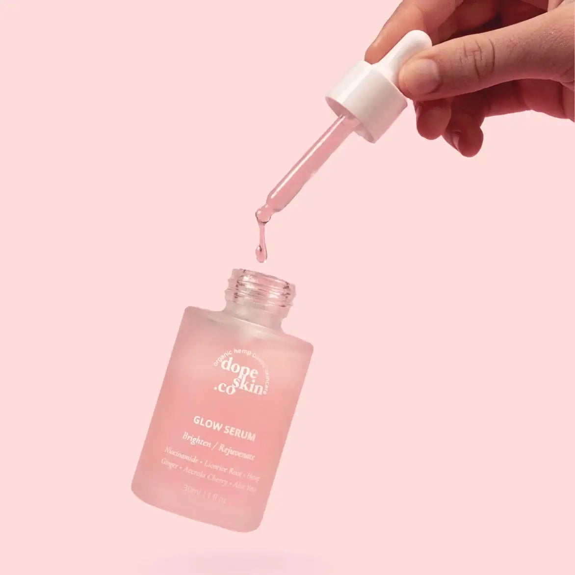 Bottle of Dope Skin Glow Serum with dropper, showcasing its luminous gel for radiant skin.