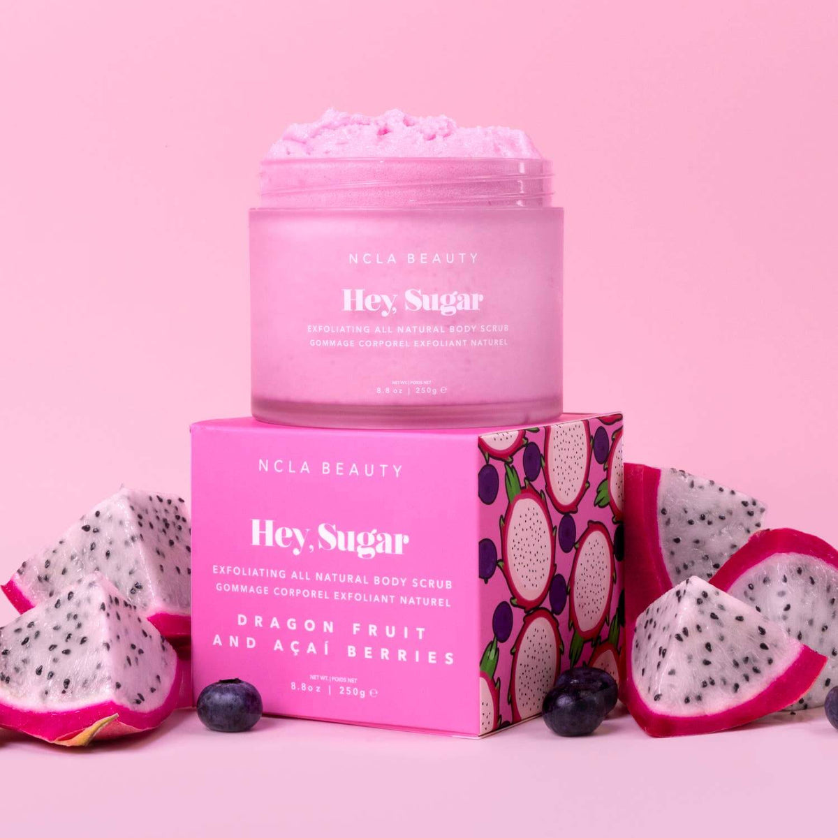 NCLA Beauty 'Hey Sugar' dragon fruit and acai berries body scrub with packaging on a pink background