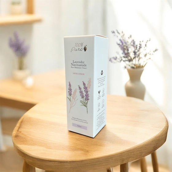 Lavender Niacinamide Pore Minimizer Tonique packaging on a table with lavender flowers in the background.