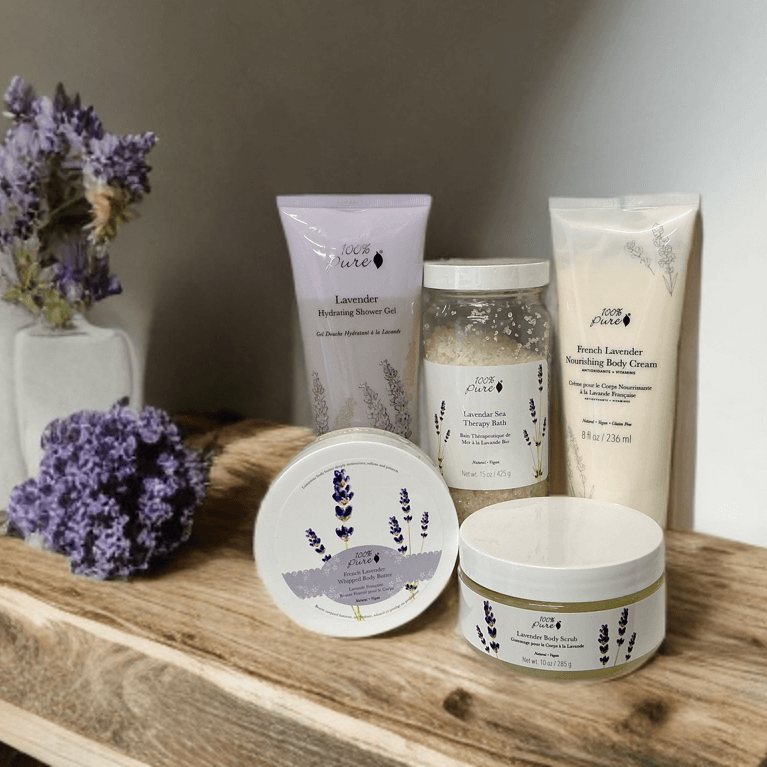 Luxury lavender bath set displayed on a wooden shelf with lavender flowers.