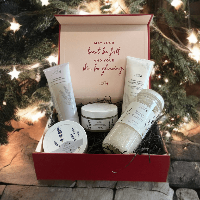 Luxury lavender bath set gift box with skin care products against a festive background.