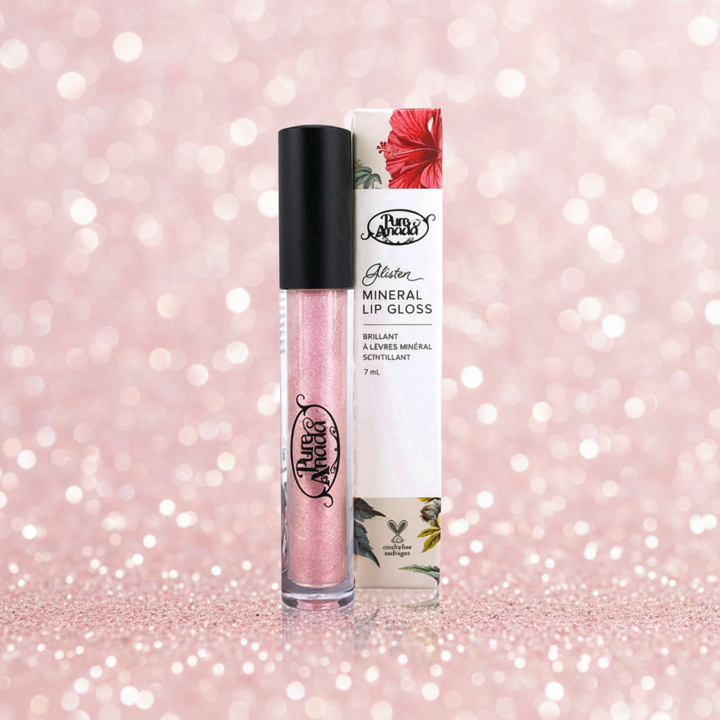 Mineral lip gloss with packaging on a pink glittery background