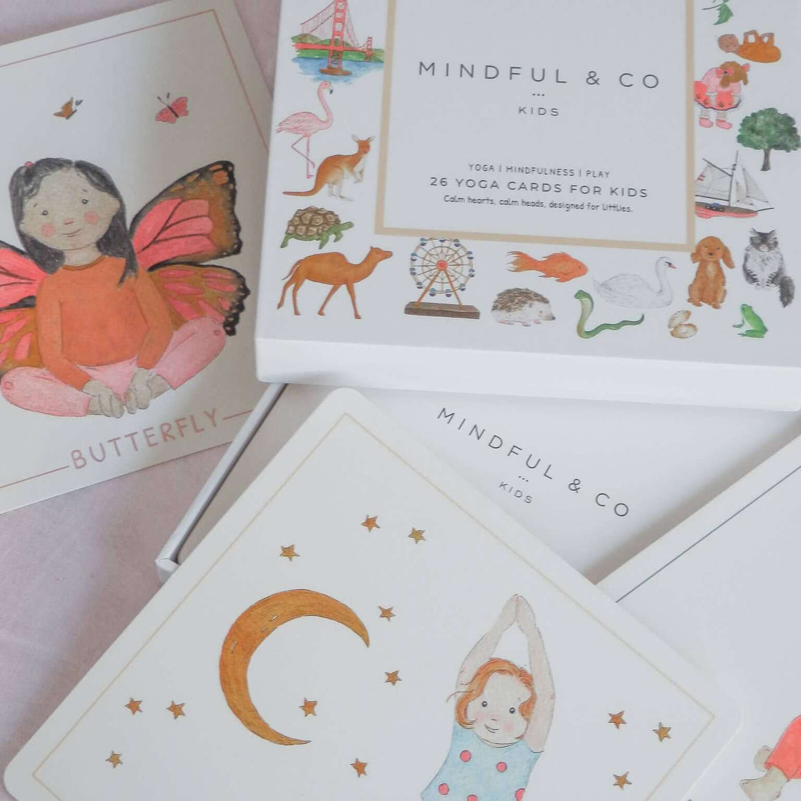 Mindful & Co kids yoga cards with illustrations on a light pink background