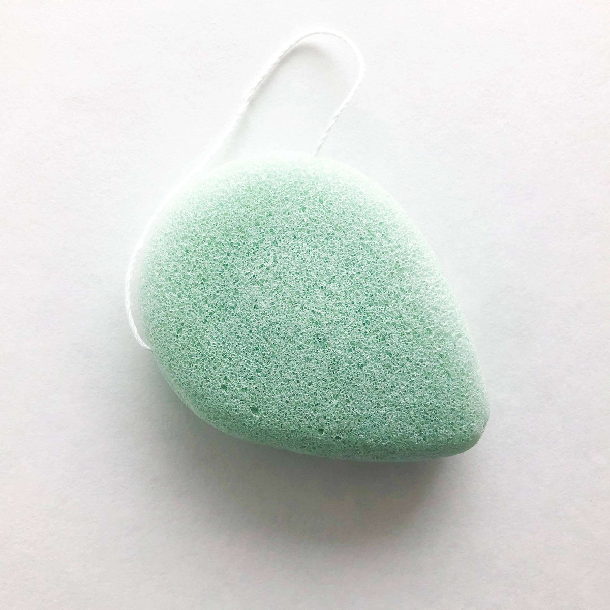 Green konjac sponge on a white background