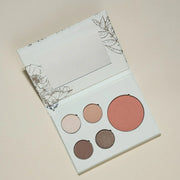 Makeup palette with five round shades on a beige background