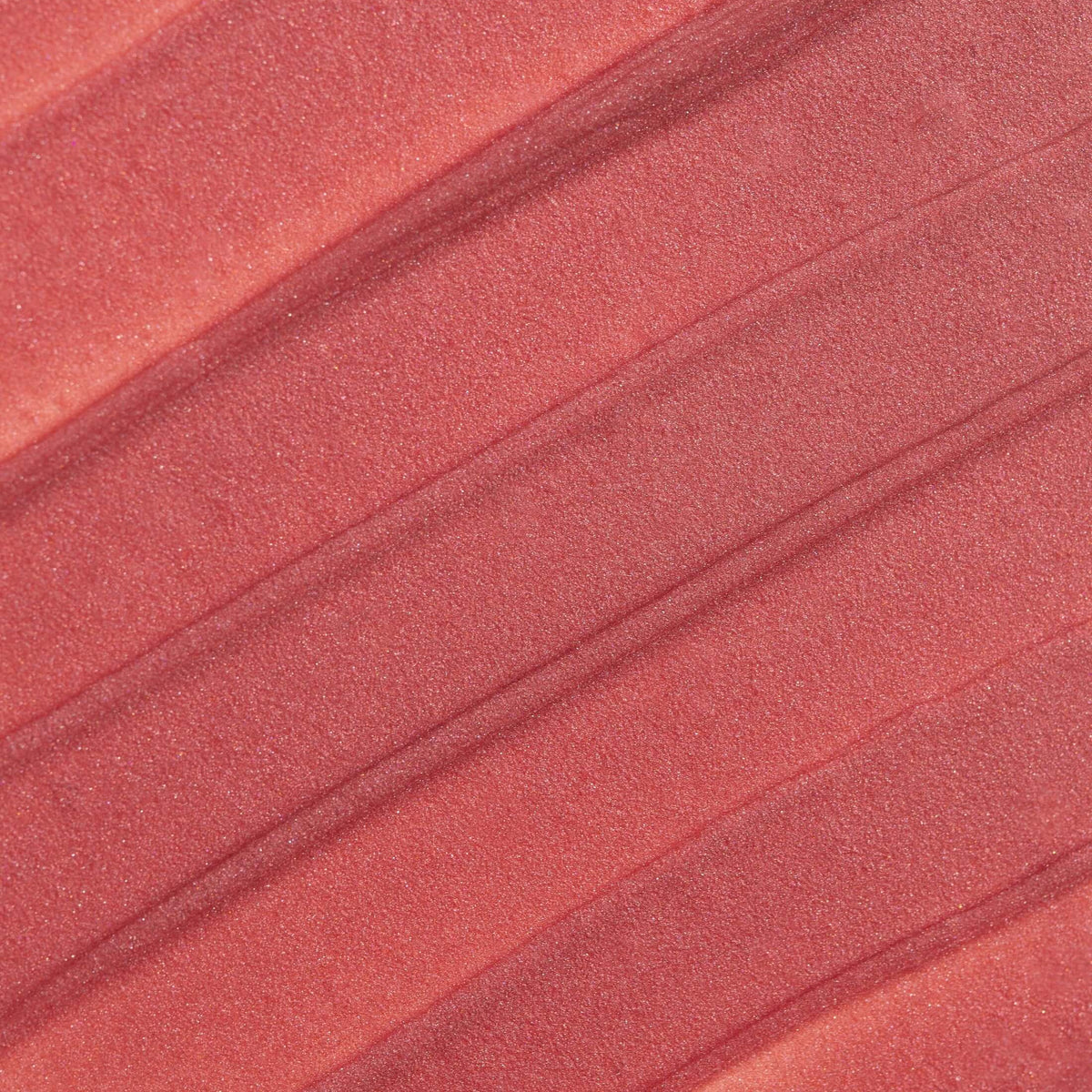 Close-up of pleated fabric with a pinkish-red color.