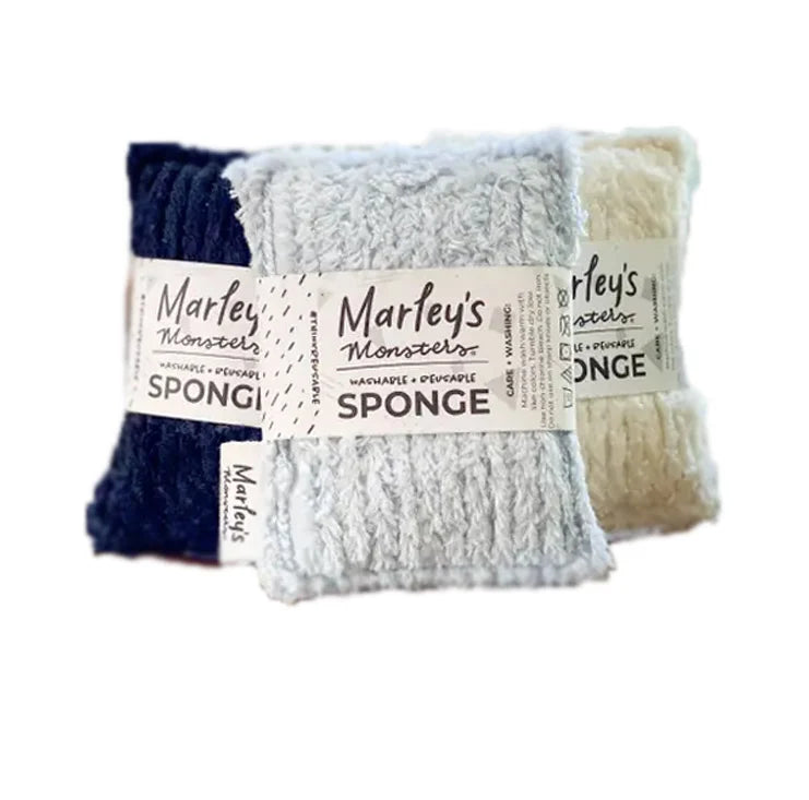 Three pairs of Marley's Monarchs washed and repiled sponge washcloths in navy blue, light blue-gray, and cream, bundled together with a paper band.