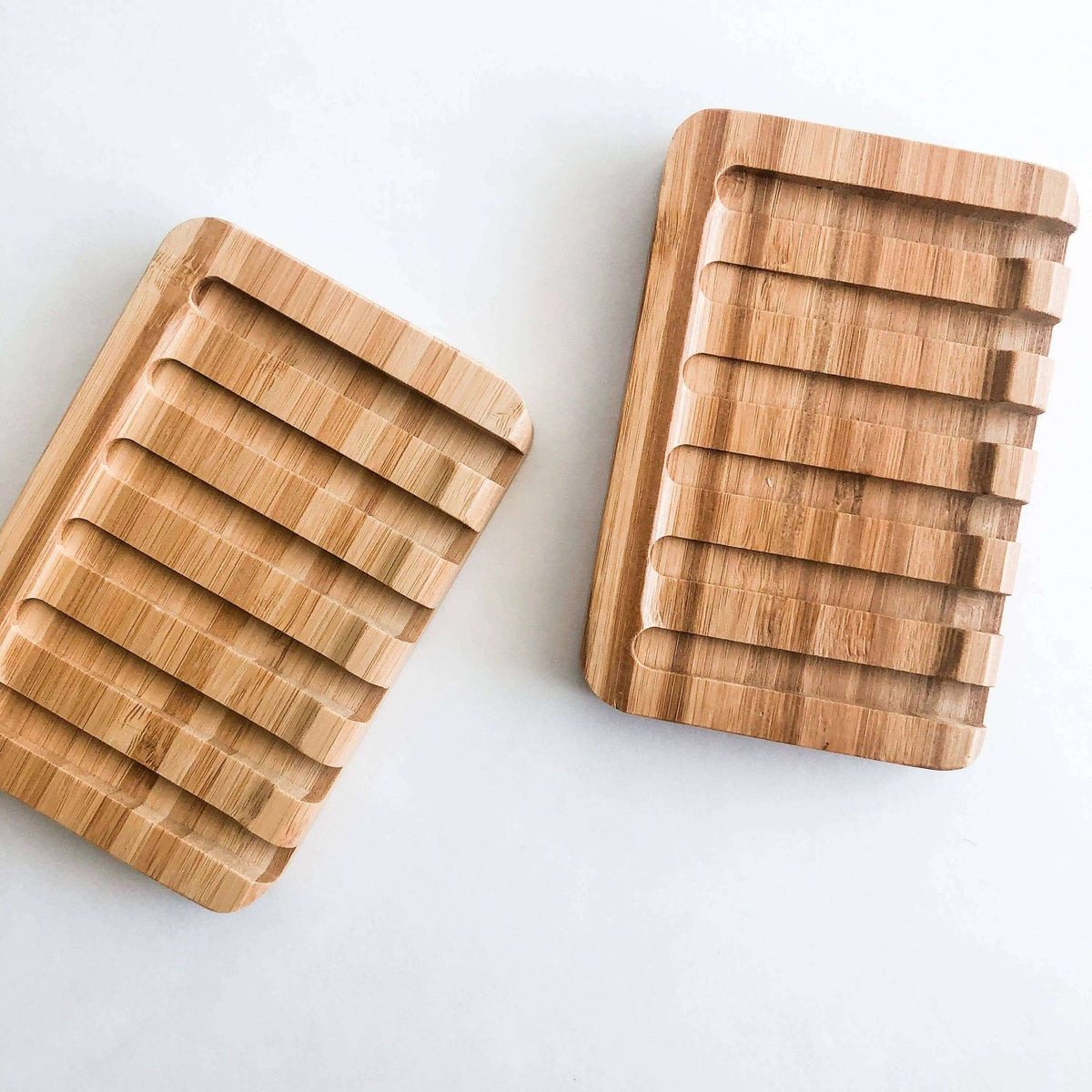Two woodenlapping boards with a striped pattern on a light gray background