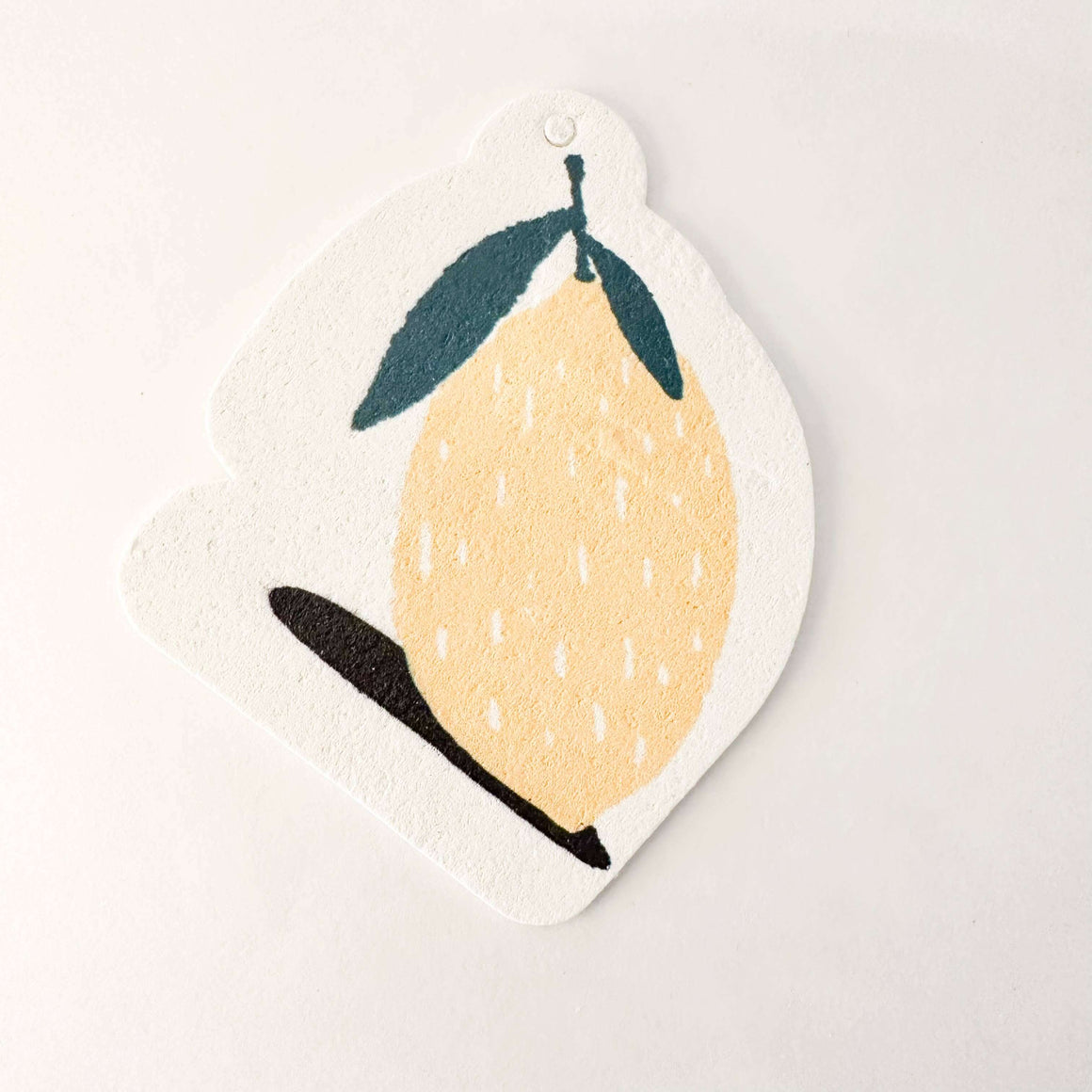 Decorative lemon-shaped sign with a yellow lemon illustration on a white background
