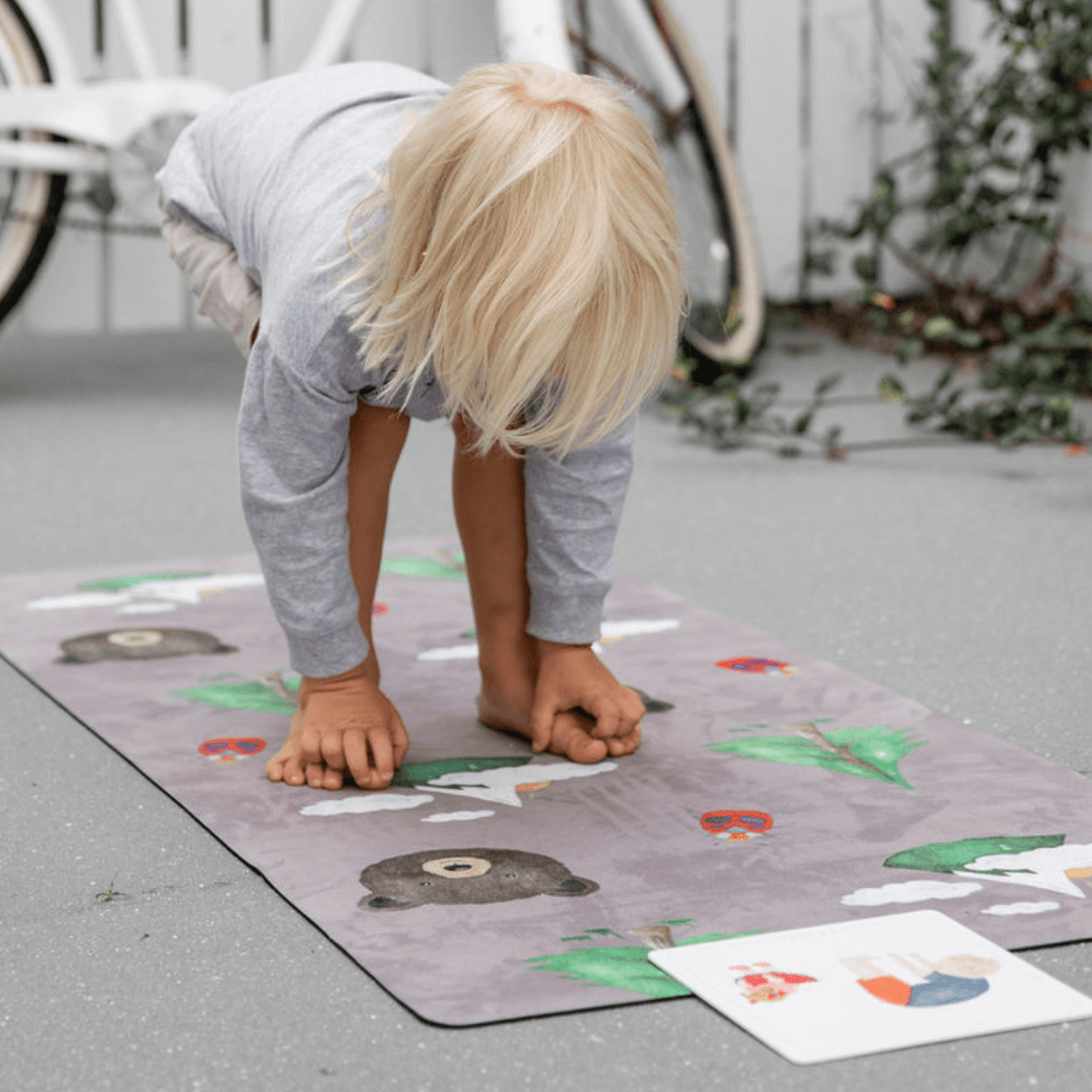 Child practicing yoga on a Nature Print Kids Yoga Mat with fun animal illustrations.
