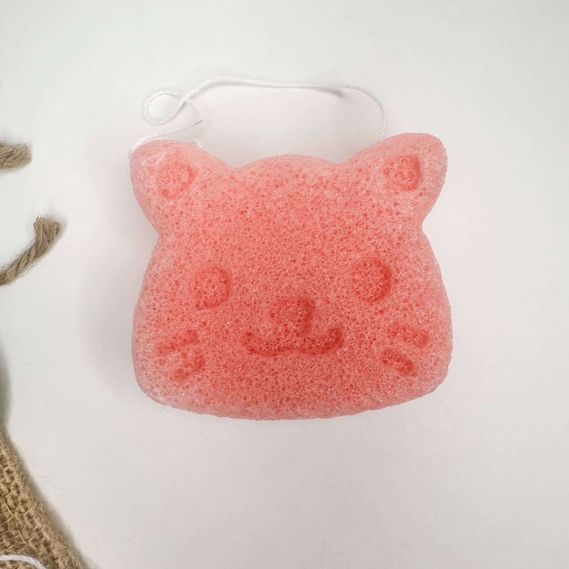 Cute pink konjac facial sponge shaped like a cat, perfect for gentle skincare with Natural Organic Konjac Facial Sponges.