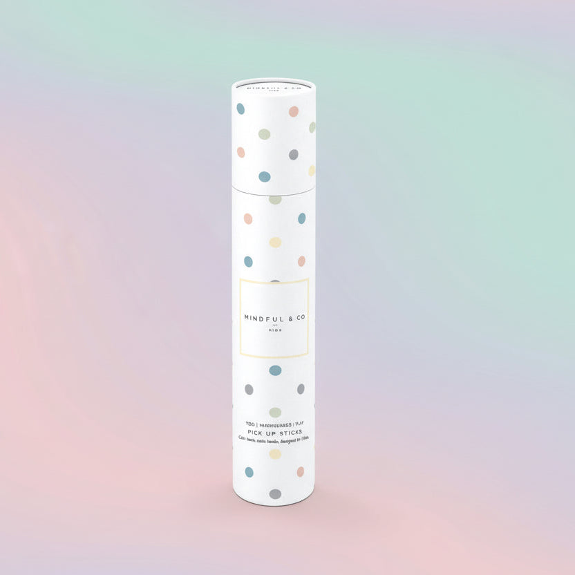 White cylindrical container with colorful polka dots on a white background